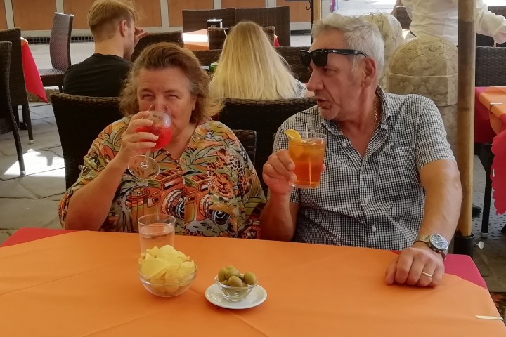 a group of people sitting at a table eating food