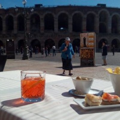 a group of people sitting at a table in front of a building