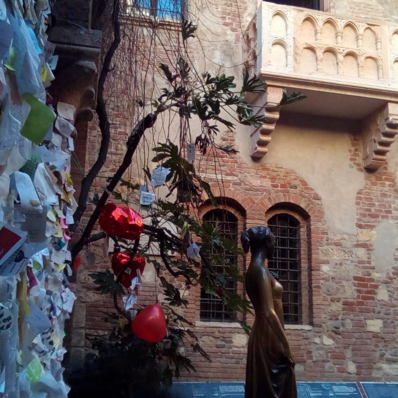 a person standing in front of a brick building
