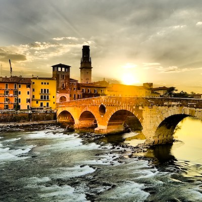 a train crossing a bridge over a body of water