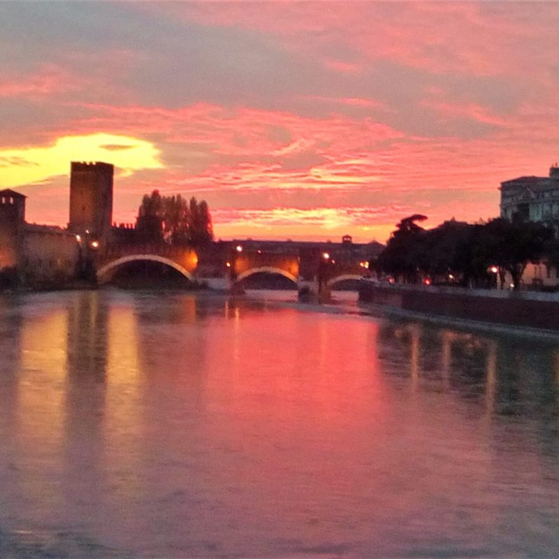 a train crossing a bridge over a body of water